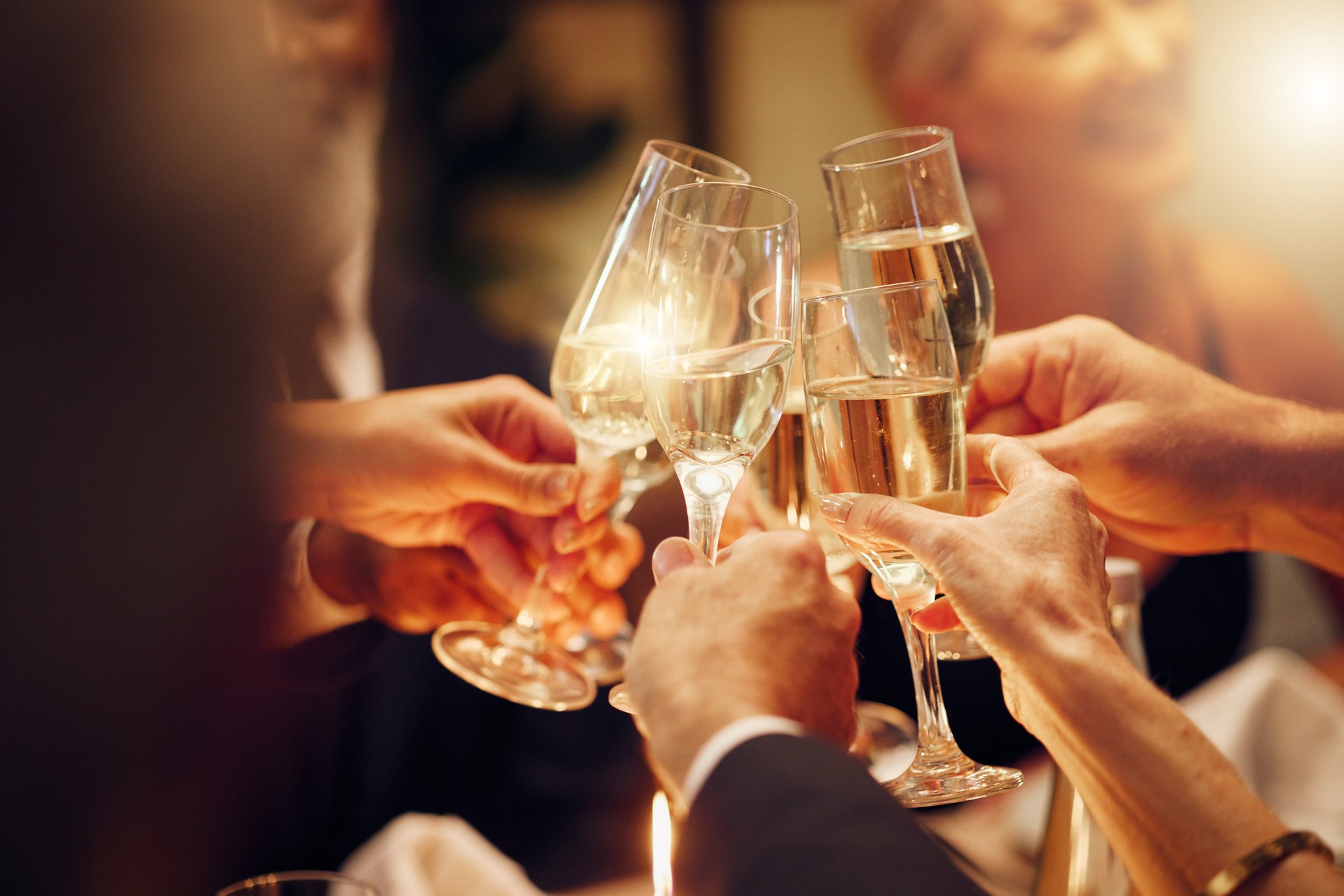 Success, hands or toast in a party for goals, winning deal or new year at luxury social event celebration. Motivation, team work or people cheers with champagne drinks or wine glasses at dinner gala